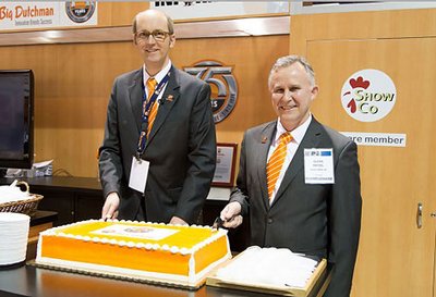 Celebrating 75 years of successful poultry systems with a huge anniversary cake.