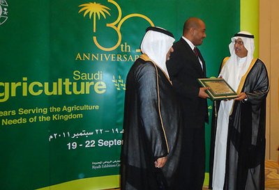 Saudi Arabia: The agricultural minister (right) and Prince Saud Bin Abdallah Al Faisal hand over the anniversary award to Khalid Abdelrahman.