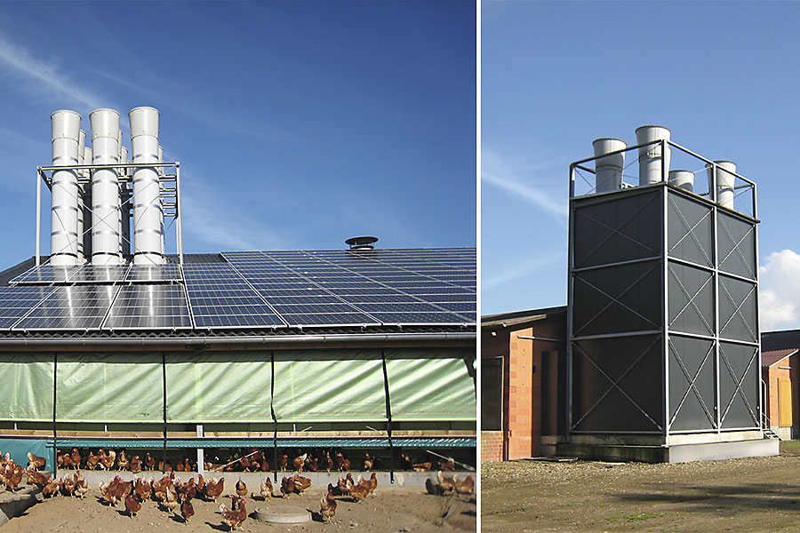 Links ein Stall mit hohen Schornsteinen und Legehennen im Vordergrund, rechts ein Stall mit hohem Abluftturm am Kopfende